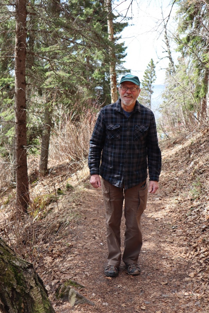 Superior Shuttle Service owner, Bob Risch, walking along the Cascade River trail.